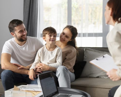 close-up-family-discussing-with-therapist